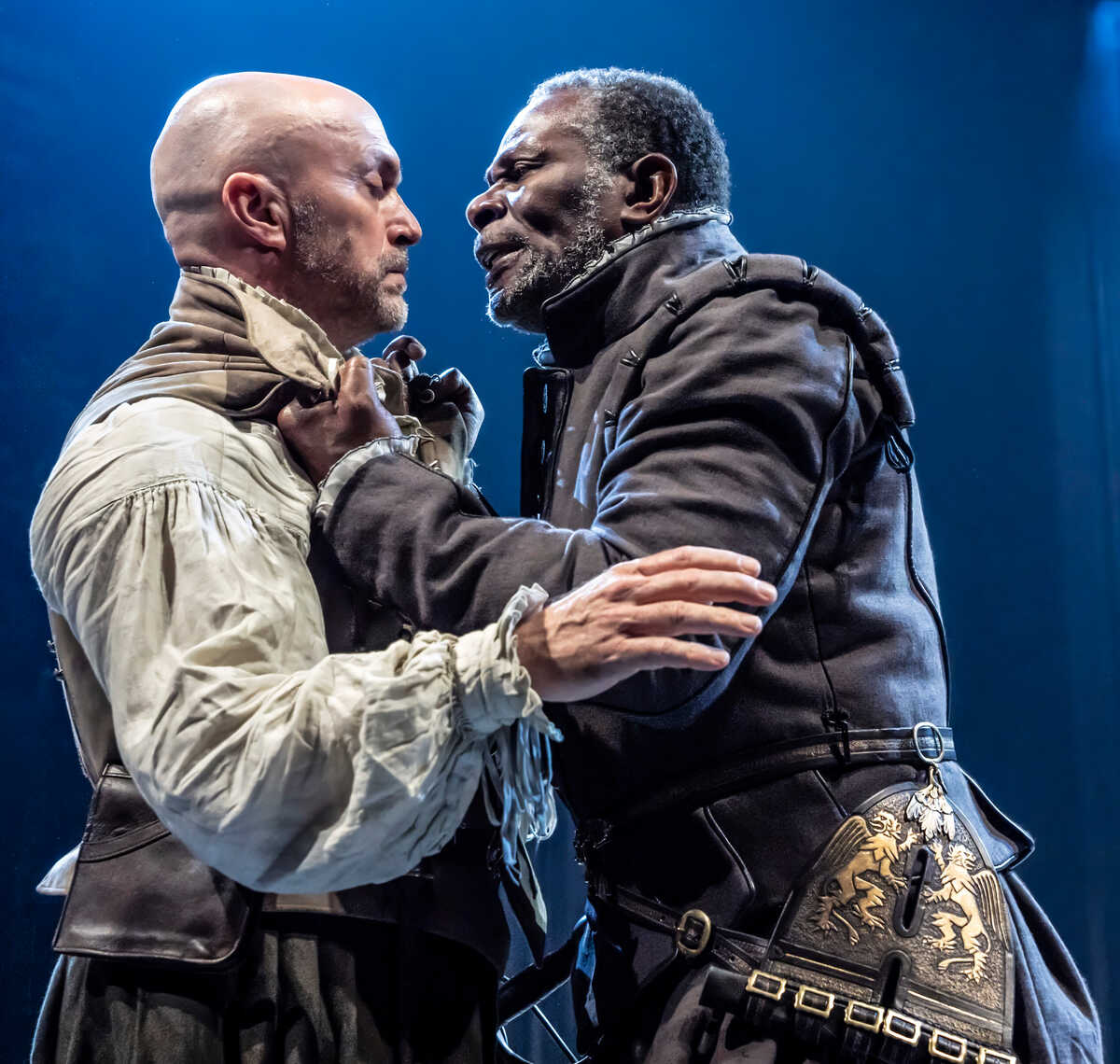 Othello grabs Iago by the jacket.